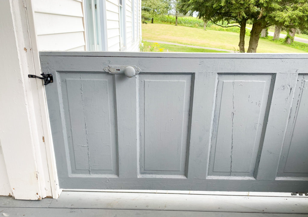 old door used as porch gate